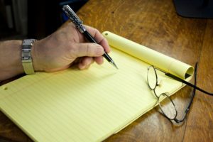 man about to start writing yellow letters